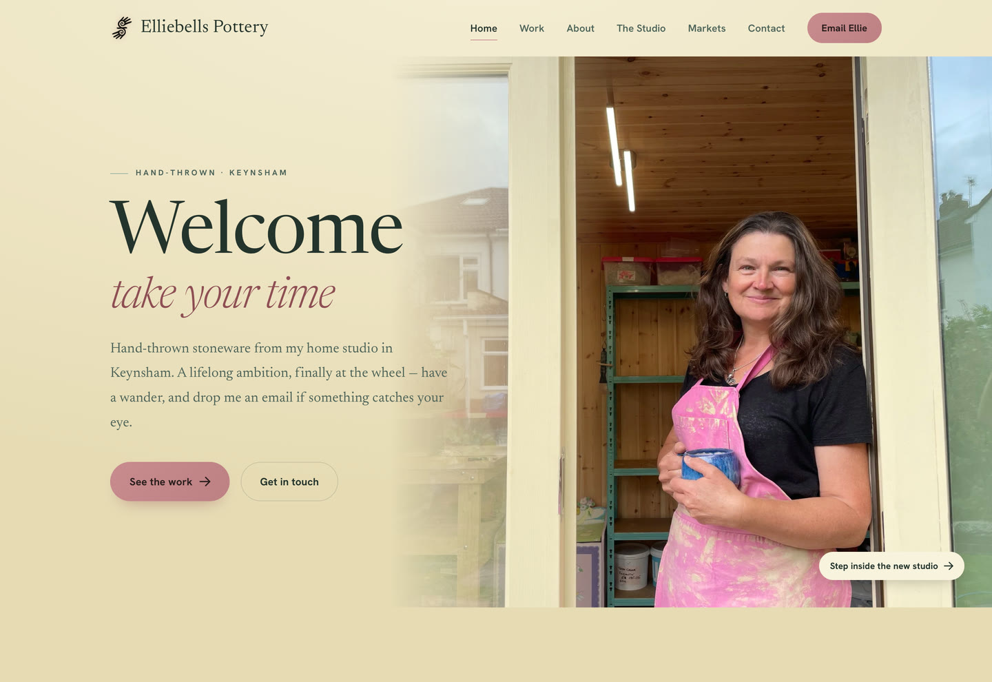 The Elliebells Pottery homepage: Ellie smiling in the doorway of her garden studio beside the words Welcome, take your time